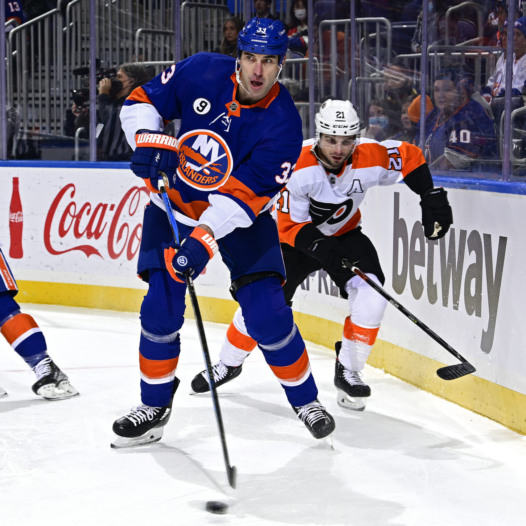 ELMONT, NEW YORK - JANUARY 25:  Zdeno Chara #33 of the New York Islanders is pursued by Scott Laughton #21 of the Philadelphia Flyers during the first period at UBS Arena on January 25, 2022 in Elmont, New York. (Photo by Steven Ryan/Getty Images)